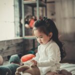 photography of a baby girl playing
