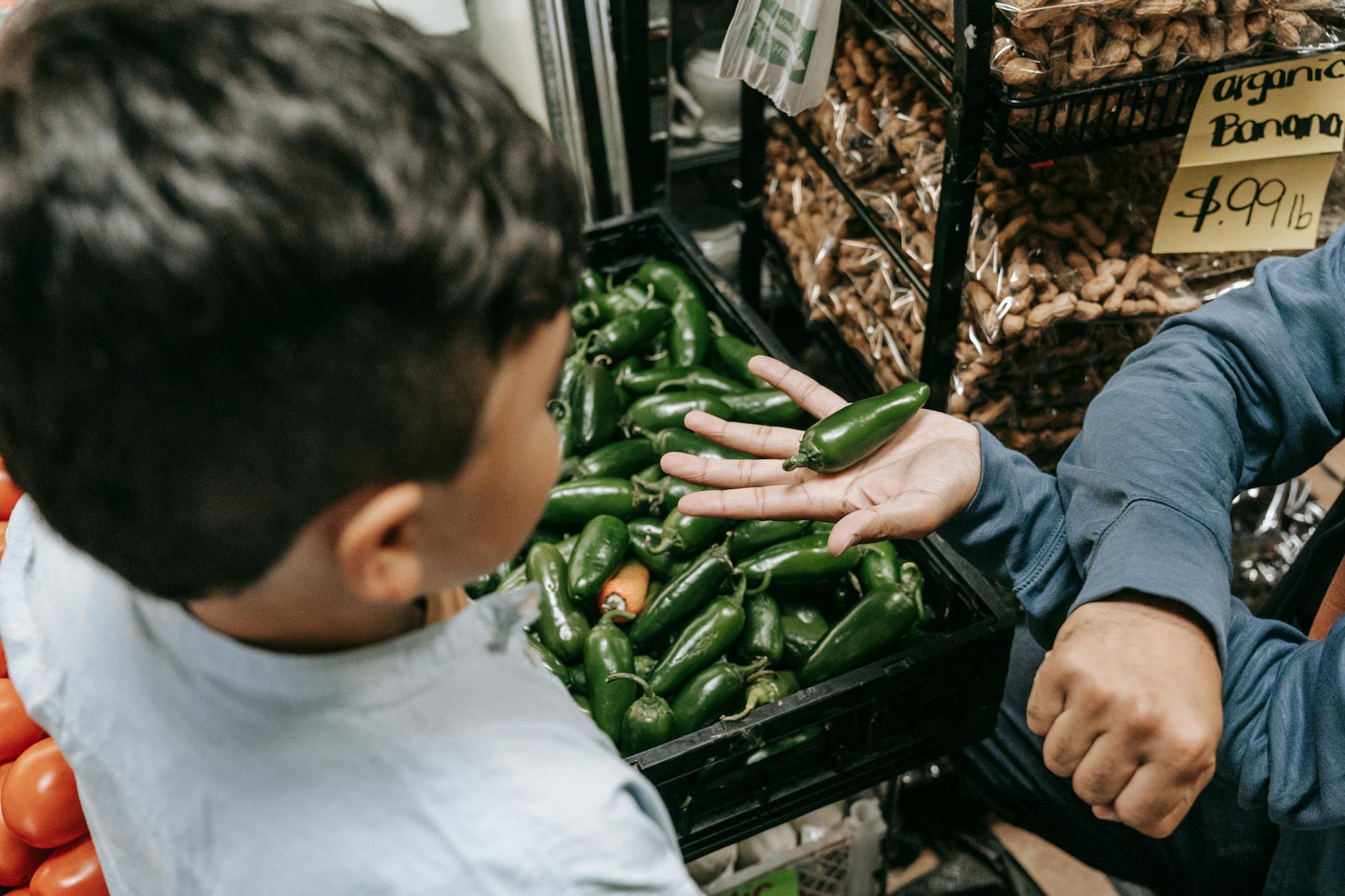 a person holding green pepper